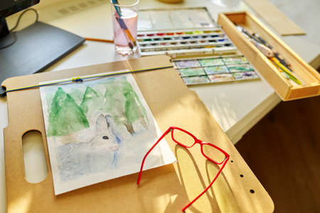 Watercolor drawing, glasses, watercolors in a box, brushes on the table, nobodyの写真素材