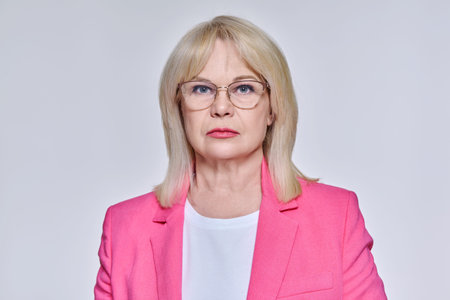Portrait of senior business successful woman in glasses looking at camera