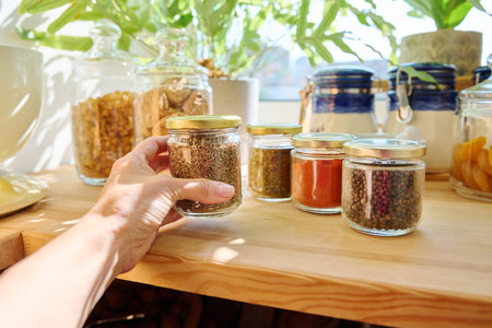 Jars with different spices in the kitchen, zira close-up