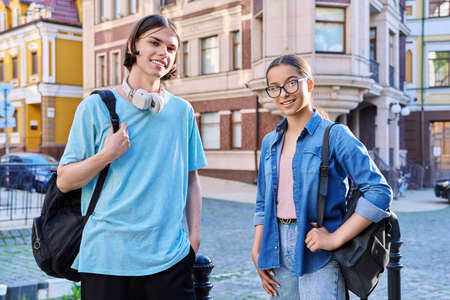 Portrait of teenage young guy and girl students looking at camera, outdoorの写真素材