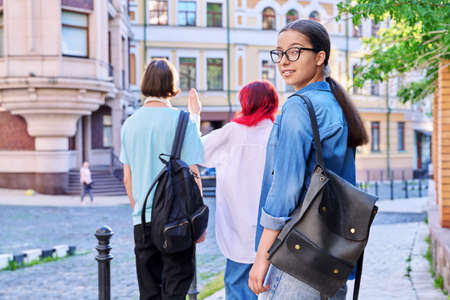 Outdoor portrait of teenage female student in city, on streetの写真素材