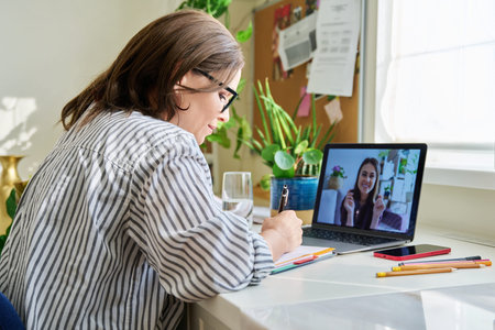 Business woman making video chat with client, partner in home office