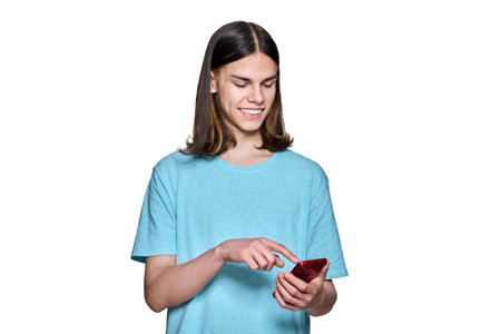 Teenager guy with smartphone in his hands on white isolated background