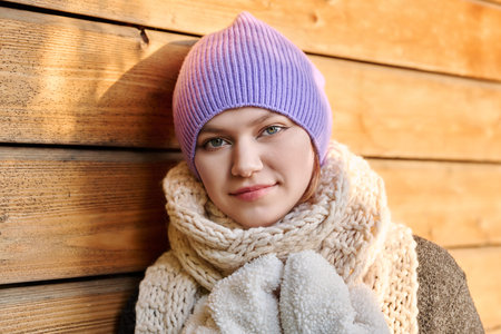 Portrait of young woman in winter knitted hat scarf mittensの写真素材