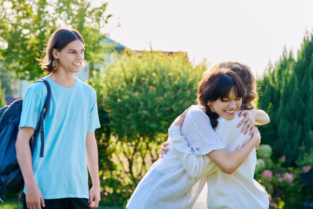 Meeting of three teenage friends, outdoor on sunny dayの写真素材