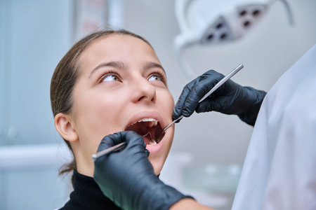 Young teenage female at dental checkup in clinic.の写真素材