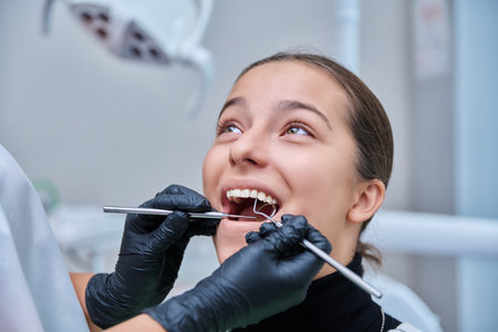 Young teenage female at dental checkup in clinicの写真素材