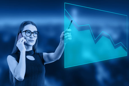 Business woman touching digital monitor with business graph on blurred backgroundの写真素材