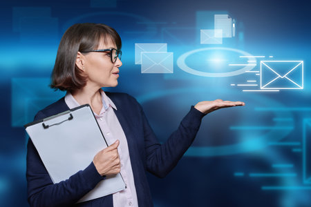 Business mature woman on urban background with mail virtual iconsの写真素材