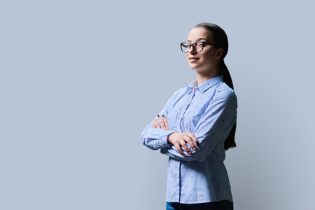 Portrait of high school student girl, copy space gray backgroundの写真素材