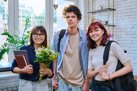 College students and female mentor teacher with bouquet of flowers