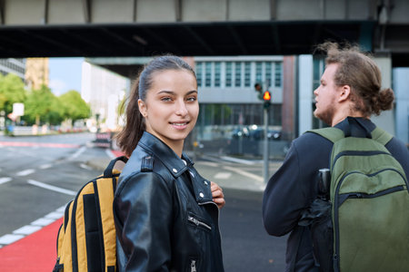 Portrait of teenage high school student girl with backpack on city street
