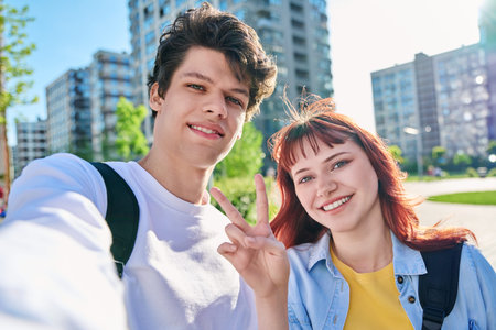 Selfie portrait of happy friends guy and girl college students looking at camera