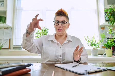 Webcam view of talking middle-aged business woman
