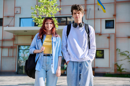 Portrait of young students guy and girl, outdoors togetherの写真素材