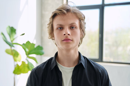 Headshot portrait of serious teenage boy looking at cameraの写真素材