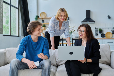 Family, mother and teenage son meeting with social worker sitting on couch at homeの写真素材