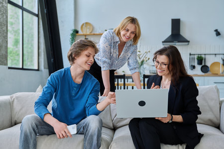 Family, mother and teenage son meeting with social worker sitting on couch at homeの写真素材