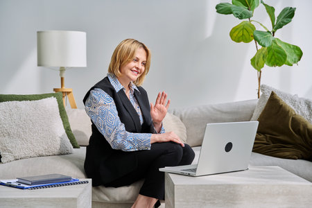 Female psychologist having online session, using laptopの写真素材