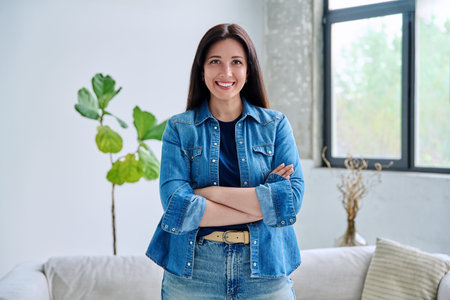 Portrait of beautiful young confident woman in home interiorの写真素材