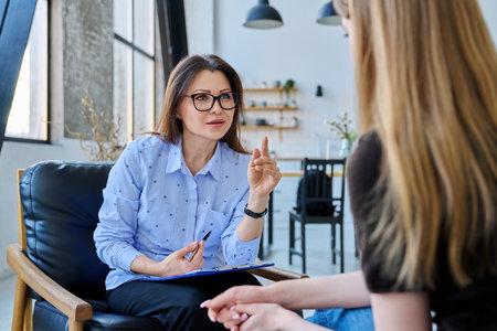 Female professional mental specialist, therapist working with patient young woman in officeの写真素材