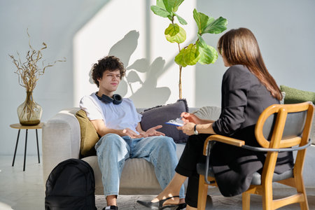 Young man patient during therapy session in professional mental therapists officeの写真素材