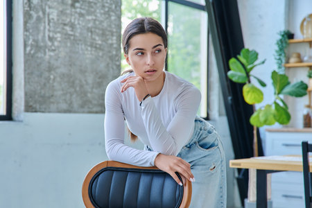 Portrait of beautiful stylish young teenage girl posing at homeの写真素材