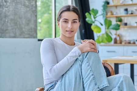 Portrait of beautiful stylish young teenage girl posing at homeの写真素材