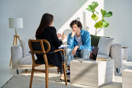 Young man in mental session talking with professional psychologist