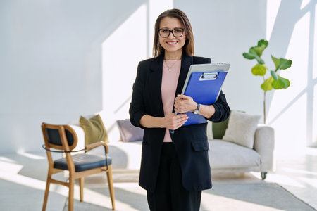 Portrait of professional psychologist therapist woman with clipboard in officeの写真素材