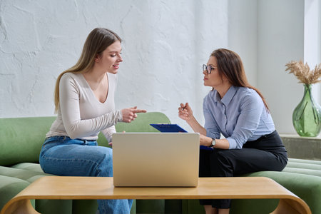Young female patient during psychotherapy session with psychologistの写真素材
