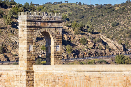 View of the very old Arch of Triumph, All which is located on the two-thousand-year-old Roman bridge. This leads across the Tagus River in Extremadura, Spain.の写真素材