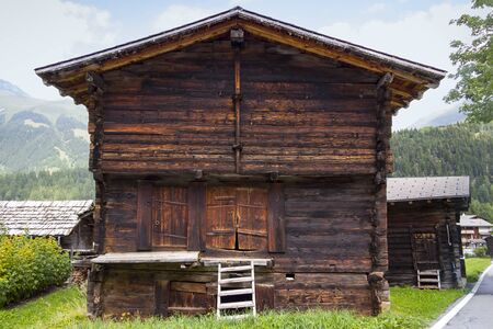 View of a rustic big barn in a village in Switzerland. You can see the typical wooden architecture.の写真素材