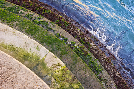 Looking at a staircase on a canal in the lagoon city Venice. Typical are these water-washed stairs.の写真素材