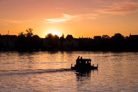 View on a very romantic part of the city Potsdam, small boat swimming on the Havel, towards the...
