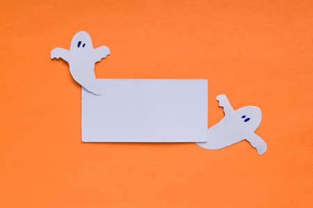 Happy Halloween holiday concept. Halloween decorations, spooky on an orange background. Card with frame for text. Copy spaceの写真素材