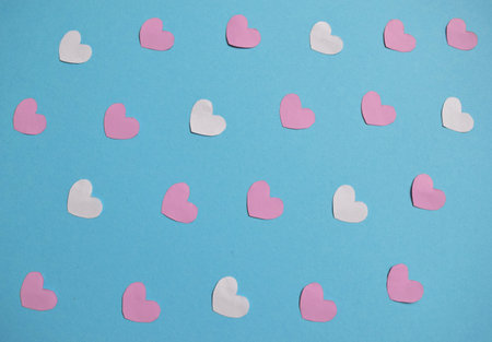 white, pink, red hearts on a blue background. Valentine's day hearts pattern. Valentines day card...