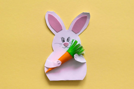 Step by step photo instruction How to make Origami paper bunny with carrot for Easter greetings card. Children's art project. DIY concept. with copy spaceの写真素材