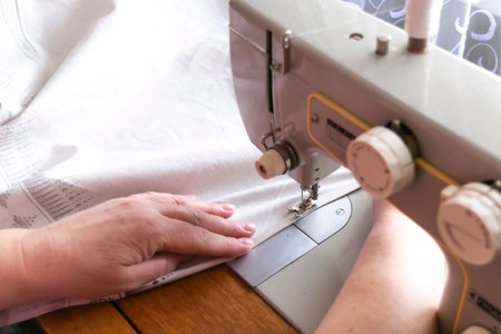 Process of sewing on a sewing machine, woman hand