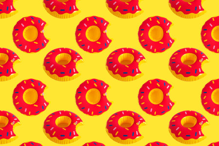 Bright inflatable ring pattern on yellow background.