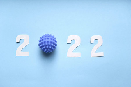happy new year 2022 with virus model on a blue background