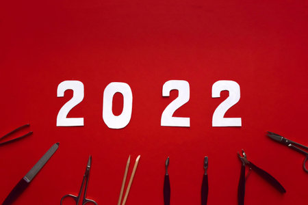 christmas and new year concept manicure tools on red background