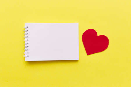 empty notebook with red heart on yellow background with space for your text. Valentine Day ,holiday, health, plan Conceptの写真素材