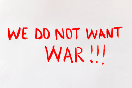 The concept of ending the war in Ukraine. Broken heart in the colors of the flag of Ukraine and Russia in female hands with text we do not want warの写真素材