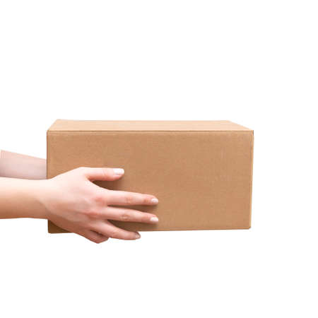 Delivery cardboard boxes in woman hand isolatedの写真素材