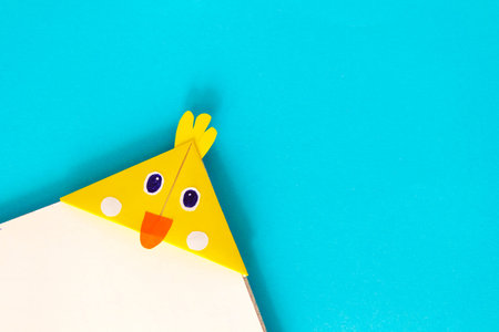 Step by step photo instruction how to make origami paper bookmark chick. Simple diy with kids...