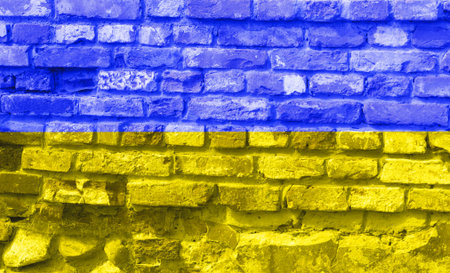 Ukrainian national flag on broken concrete wall with cracks background, abstract Ukraine politics...