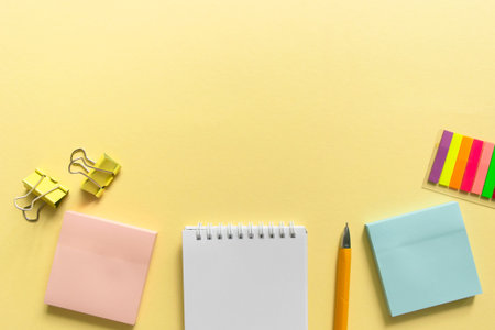 Back to school background. School accessories on a yellow background. Top view with copy space