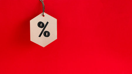 Black friday. Sale tag on the red background with copy spaceの写真素材