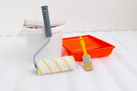 Paint can, roller and paint tray for painting wall on the floor.の写真素材